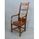 AN OAK AND YEW ELBOW CHAIR, THE TOP TWO OF THE REEDED BARS TO THE TALL BACK CENTRED BY THREE