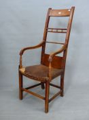 AN OAK AND YEW ELBOW CHAIR, THE TOP TWO OF THE REEDED BARS TO THE TALL BACK CENTRED BY THREE