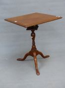 AN ANTIQUE MAHOGANY BIRDCAGE TABLE, THE SQUARE TOP TILTING ON THE BALUSTER COLUMN AND TRIPOD WITH