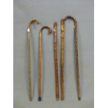 TWO BRASSICA WALKING STICKS, A JAPANESE CARVED BAMBOO CANE, ANOTHER BAMBOO CANE TOGETHER WITH A