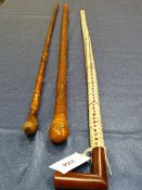 A WOODEN HANDLED STING RAY SPINE WALKING STICK. H 93cms,, A BAMBOO WALKING CANE TOGETHER WITH A