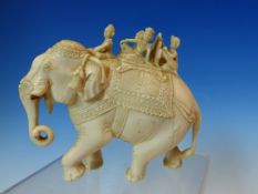 AN INDIAN IVORY GROUP OF FOUR FIGURES BORNE ON AN ELEPHANT. W 11cms.