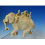 AN INDIAN IVORY GROUP OF FOUR FIGURES BORNE ON AN ELEPHANT. W 11cms.