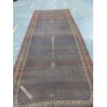 AN ANTIQUE PERSIAN SERREBAND GALLERY RUG. 448 x 189cms.