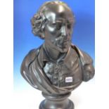 A BLACK PAINTED PLASTER BUST OF SHAKESPEARE WEARING A CLOAK OVER HIS TASSELL TIED SHIRT AND
