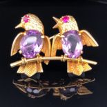 TWO BIRDS ON A BRANCH BROOCH, 18ct GOLD FORMS WITH AMETHYST BODIES AND RUBY EYES. APPROX 4cms X
