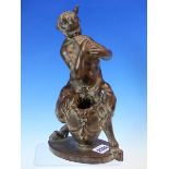 A BRONZED TERRACOTTA FIGURE OF A SATYR SEATED ON A VASE PLAYING PAN'S PIPES, AFTER F W POMEROY. H