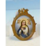 A GERMAN PORCELAIN OVAL PLAQUE PAINTED WITH THE IMMACULATE CONCEPTION OF THE MADONNA AFTER