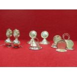 A PAIR OF HALLMARKED SILVER PLACECARD HOLDERS IN THE FORM OF FLAMING GRENADES, A FURTHER PAIR IN THE