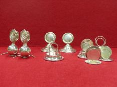 A PAIR OF HALLMARKED SILVER PLACECARD HOLDERS IN THE FORM OF FLAMING GRENADES, A FURTHER PAIR IN THE