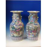 A PAIR OF CANTON VASES PAINTED WITH WARRIOR AND COURT RESERVES ON A GROUND OF BIRDS AMONGST PINK