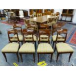A SET OF EIGHT BIEDERMEIER MAHOGANY DINING CHAIRS, THE BROAD TOP RAILS OVER CRUCIFORM BARS,