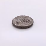 A SILVER COIN WITH THE HEAD OF NERO ON ONE SIDE AND AN EAGLE ON THE REVERSE