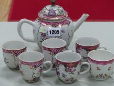 A CHINESE EXPORT FLORAL TEA POT, THREE COFFEE CUPS EN SUITE, A PAIR AND ONE OTHER COFFEE CUP, ALL