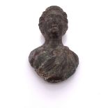 A ROMAN BRONZE BUST WITH A TOGA DRAPED OVER THE LEFT SHOULDER. H 4cms.