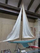 A LARGE EARLY 20th.C. RIGGED POND YACHT "WHO CARES", WITH BRASS FITTINGS, BLUE PAINTED HULL AND