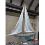A LARGE EARLY 20th.C. RIGGED POND YACHT "WHO CARES", WITH BRASS FITTINGS, BLUE PAINTED HULL AND