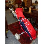A SPALDING RED GOLF BAG AND TROLLEY, THE BAG CONTAINING NINE COBRA IRON CLUBS, TWO OTHERS BY