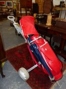 A SPALDING RED GOLF BAG AND TROLLEY, THE BAG CONTAINING NINE COBRA IRON CLUBS, TWO OTHERS BY