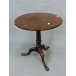 AN ANTIQUE CIRCULAR TILT TOP TABLE ON GUN BARREL COLUMN AND TRIPOD WITH LONG NOSE CLUB FEET. Dia.