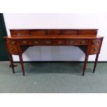 A REGENCY MAHOGANY SIDEBOARD, THE RECESSED GALLERY BACK WITH TWO LINE INLAID SLIDING DOORS, THE