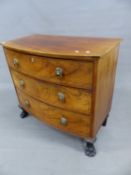 A SMALL REGENCY MAHOGANY BOW FRONT CHEST OF THREE LONG GRADUATED DRAWERS, WITH LION MASK BRASS