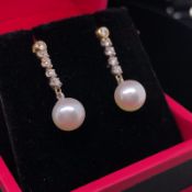A PAIR OF YELLOW GOLD CULTURED PEARL AND DIAMOND DROP EARRINGS. GROSS WEIGHT 1.7grms.
