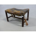 A GEORGE III MAHOGANY STOOL, THE LEATHER COVERED BOWED SEAT ON SQUARE SECTIONED LEGS JOINED BY AN