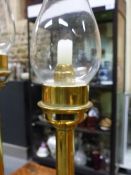 TWO BRASS CANDLESTICKS, SPRING LOADED TO TAKE WAX CANDLES AND WITH DETACHABLE STORM SHADES, THE