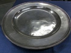 AN 18th C. PEWTER CHARGER, THE RIM BEARING THE PEWTERERS TOUCH MARK G S. Dia. 51cms.