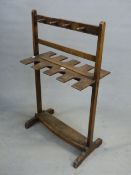 A 19th C. MAHOGANY BOOT AND WHIP RACK, EACH SIDE TO TAKE TWO PAIRS OF BOOTS AND FOUR WHIPS. W 57 x D