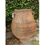 A TERRACOTTA ROMAN URN WITH THREE LUG HANDLES TO THE BELLIED SHAPE, THE RIM. Dia. 49 x H 106cms.