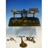FOUR LETTER SCALES, THE LARGEST BY SAMSON MORDAN WITH SIX BRASS WEIGHTS RESTING ON THE GREEN LEATHER