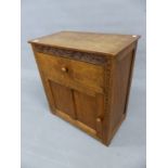 A THOMAS GNOME MAN WHITAKER ARTS AND CRAFTS OAK CABINET, THE DRAWER AND DOOR BELOW S-SCROLL