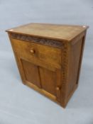 A THOMAS GNOME MAN WHITAKER ARTS AND CRAFTS OAK CABINET, THE DRAWER AND DOOR BELOW S-SCROLL