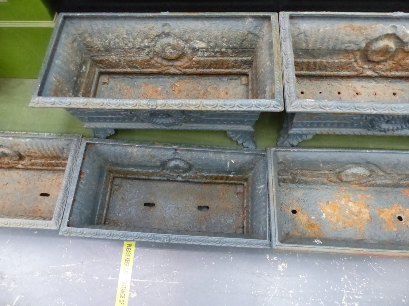 A HARLEQUIN SET OF SIX ANTIQUE IRON PLANTERS, THE RECTANGULAR RIMS OVER FLUTED BANDS AND CENTRAL - Image 7 of 11