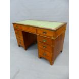 A TEAK CAMPAIGN STYLE PEDESTAL DESK, THE BRASS EDGED RECTANGULAR TOP INSET WITH LEATHER ABOVE