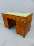 A TEAK CAMPAIGN STYLE PEDESTAL DESK, THE BRASS EDGED RECTANGULAR TOP INSET WITH LEATHER ABOVE