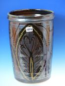 A DAVID EELES CYLINDRICAL JAR, THE TEMMOKU GLAZED BODY PAINTED ON THE EXTERIOR WITH LEAVES