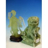 A CHINESE HARDSTONE CARVING OF A LADY HOLDING A FAN AND A FLOWER. H 16.5cms. WITH WOOD STAND AND