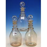 THREE SIMILAR TRIPLE RING NECKED GLASS DECANTERS AND STOPPERS TOGETHER WITH THREE OTHERS LATER