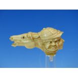 A MARINE IVORY WALKING STICK HANDLE CARVED AS A RACE HORSE HEAD TO ONE SIDE OF THREE JOCKEY FACES,