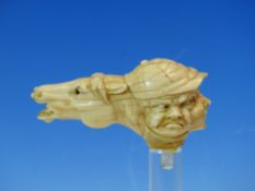 A MARINE IVORY WALKING STICK HANDLE CARVED AS A RACE HORSE HEAD TO ONE SIDE OF THREE JOCKEY FACES,