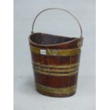 AN EARLY 19th.C. MAHOGANY OVAL PEAT BUCKET WITH BRASS HANDLE AND COOPERED SIDES. W 33.5 x H 35cms