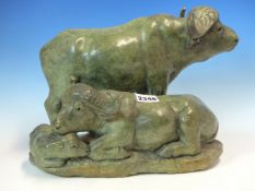 RICHARD MAISTRI, A GREENSTONE CARVING OF A WILDEBEESTE FAMILY, THE MOTHER AND CALF RECLINING TO