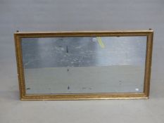 A 19th C. RECTANGULAR MIRROR IN A GILT FRAME WITH BEAD AND HUSK BANDS. 122 x 65cms.