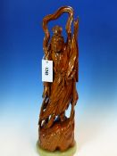 A CHINESE CARVED WOOD FIGURE OF A WINGED DEITY POINTING TO THE SKY WITH HIS LEFT HAND AND THE