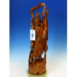 A CHINESE CARVED WOOD FIGURE OF A WINGED DEITY POINTING TO THE SKY WITH HIS LEFT HAND AND THE