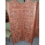 A VINTAGE EASTERN HARDWOOD CARVED FOLDING SCREEN