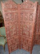 A VINTAGE EASTERN HARDWOOD CARVED FOLDING SCREEN